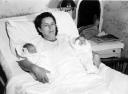 Twins Diane and Daniel are held by their mother Mary in the hospital