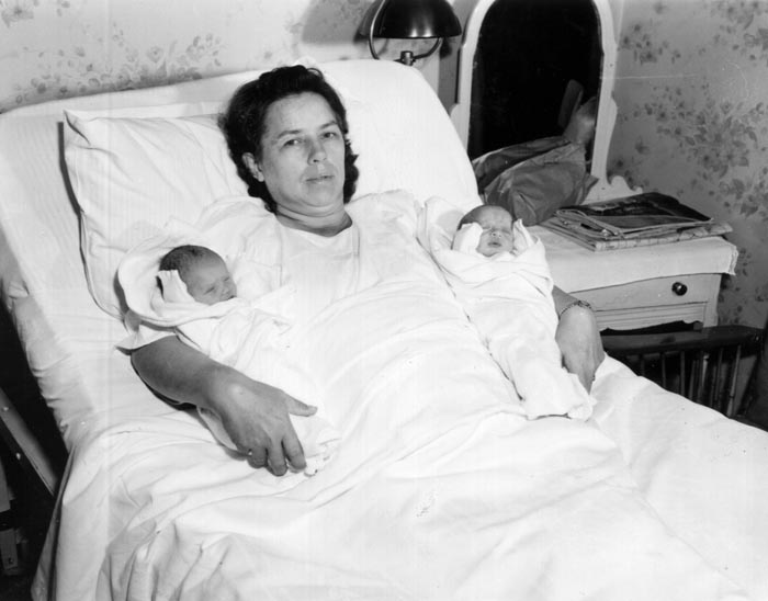 Mary Dreffs holds her youngest children, twins Daniel and Diane